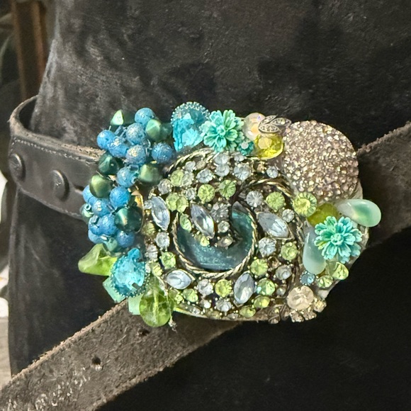 Embellished belt buckle with vintage brooches and earrings.